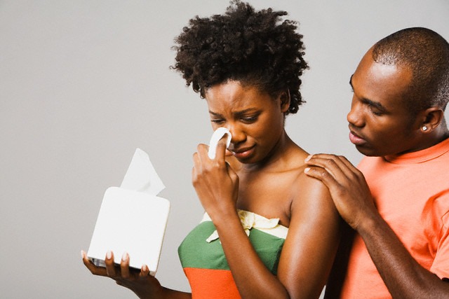 African American man comforting crying girlfriend