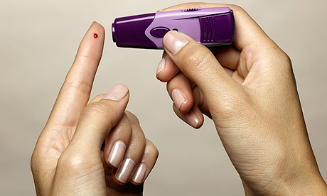 Woman using diabetes test kit