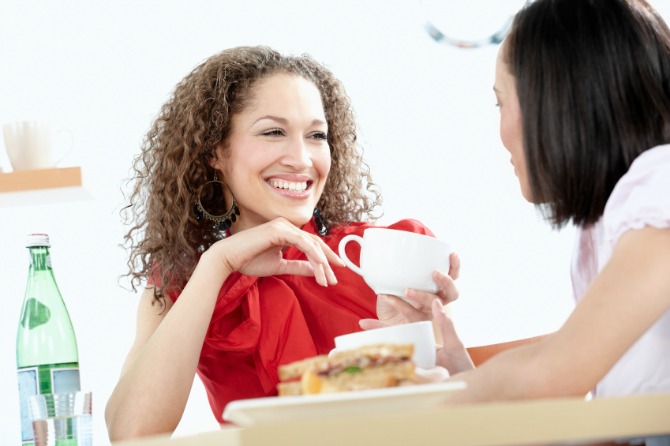 two mixed race women enjoy a cofee break after shopping