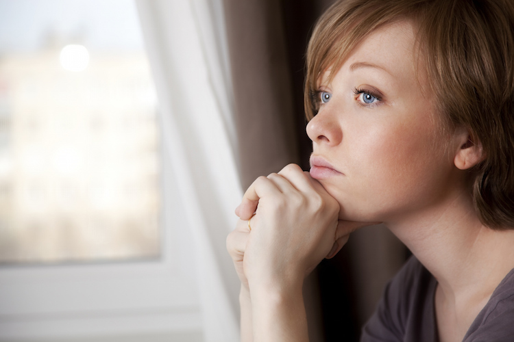 sad woman in window