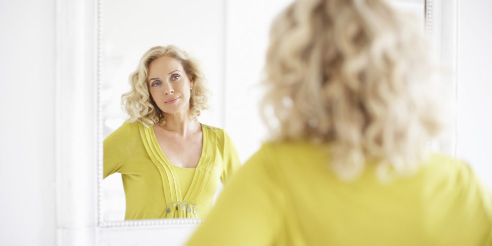 Woman looking in mirror