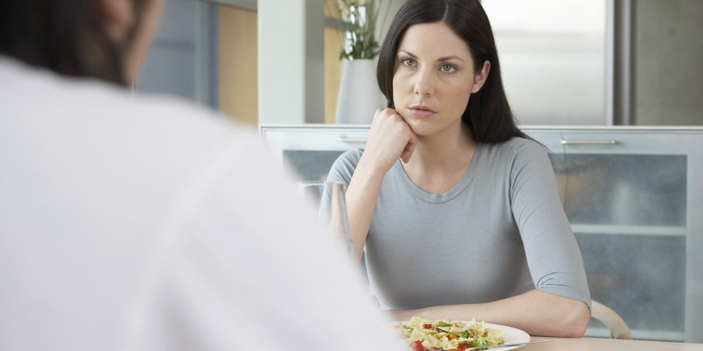 Woman sitting with man for dinner