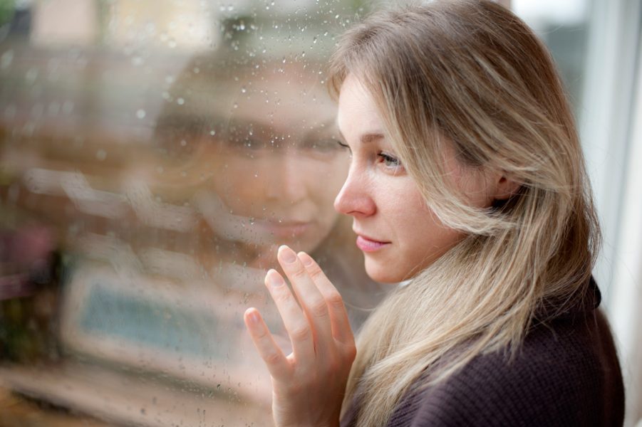 woman looking out of window