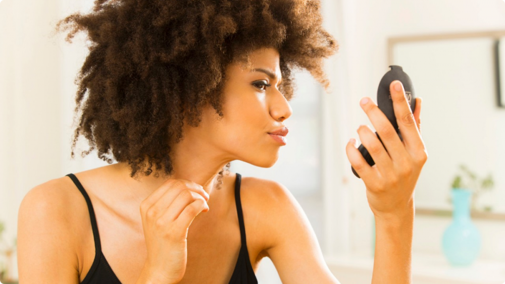 woman looking in mirror