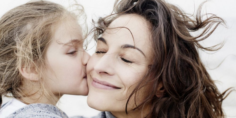 Daughter kissing mother