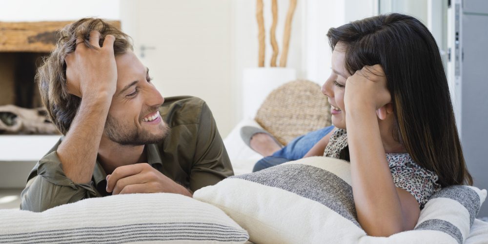 Couple lying on the bed and smiling